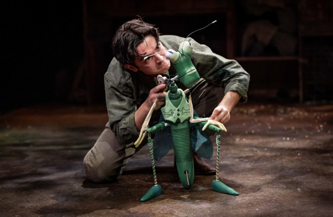 A production shot of Fred Double playing the cricket. (The circket is a green hand held puppet)